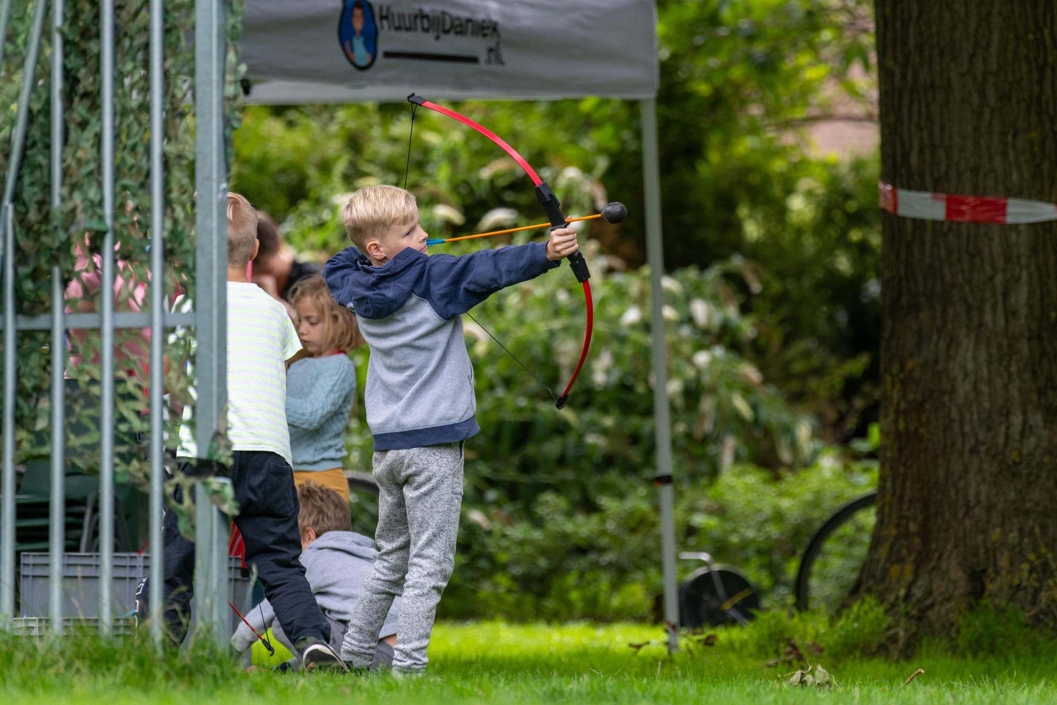 Archery tag feestje, tips met een jongen die buiten pijl en boog schiet